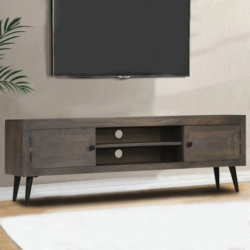 Modern dark wood TV stand with two cabinets and open shelves under a wall-mounted flat screen TV in a minimalistic living room