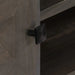 Close-up of a black square metal drawer knob on dark brown wooden furniture at Little and Giant Explorers