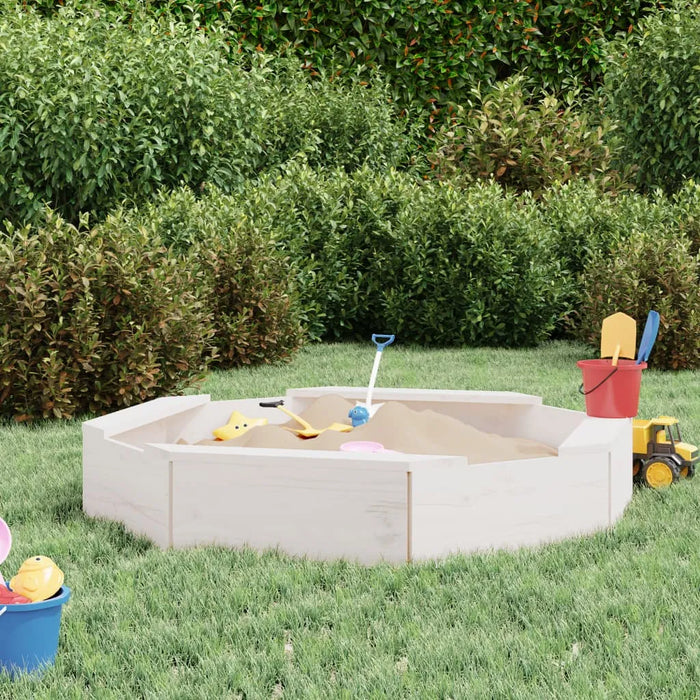Square wooden sandbox with white finish, four seats, toys, and buckets on grass garden