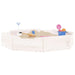 Square wooden sandbox with four corner seats, white finish, toys and sand inside
