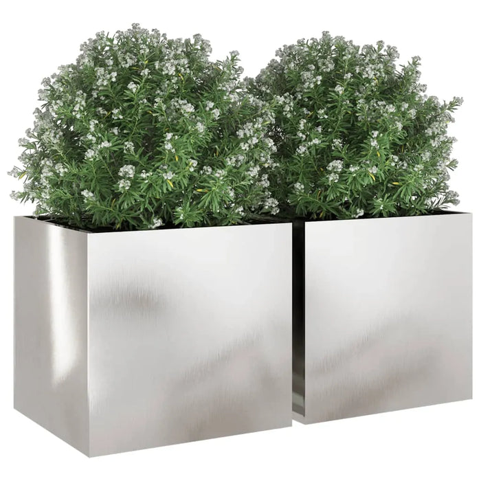 2-piece stainless steel garden planter set with green leafy plants and white flowers