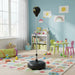 Black freestanding punching bag in colorful toddler playroom with toys, table, and blue walls