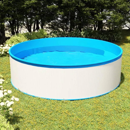 Steel frame round white and blue splasher pool set up on grass in a backyard garden.