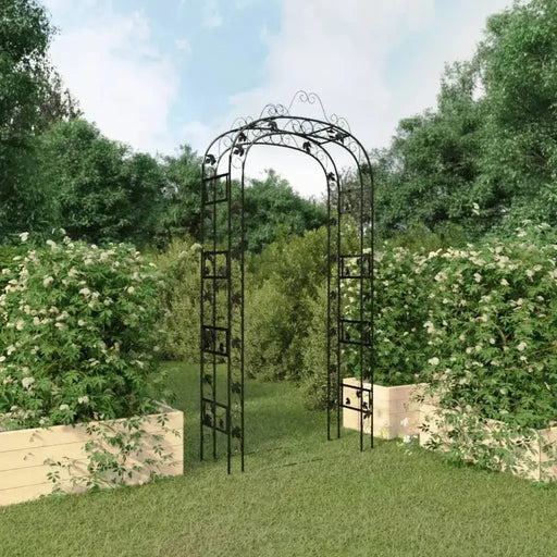 Steel garden arch trellis in lawn with raised flower beds and greenery