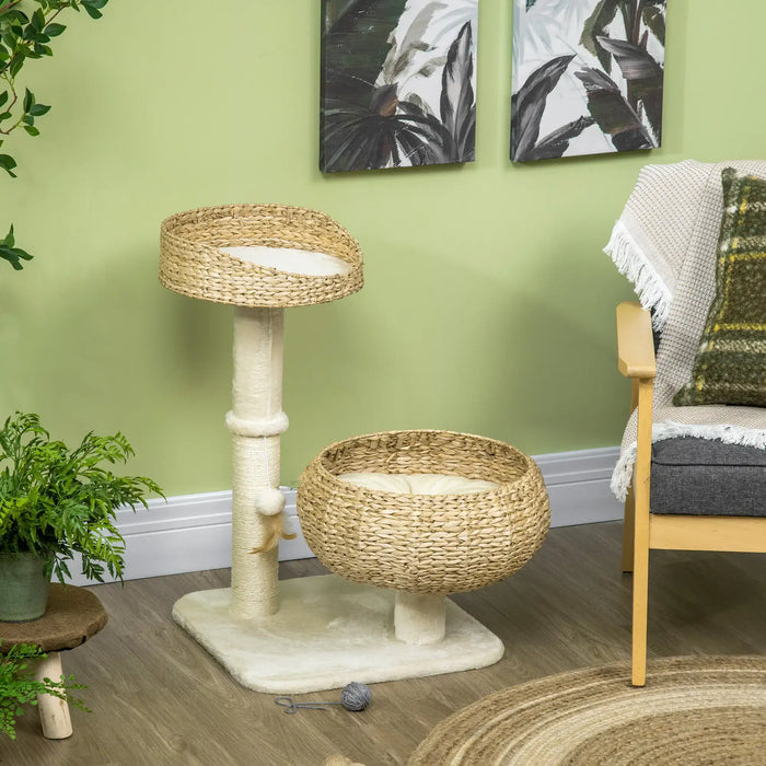 Two-tier woven cat tree with cream cushions and dangling toy in cozy living room corner