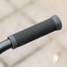 Close-up of black rubber stunt scooter handle grip with ribbed texture outdoors
