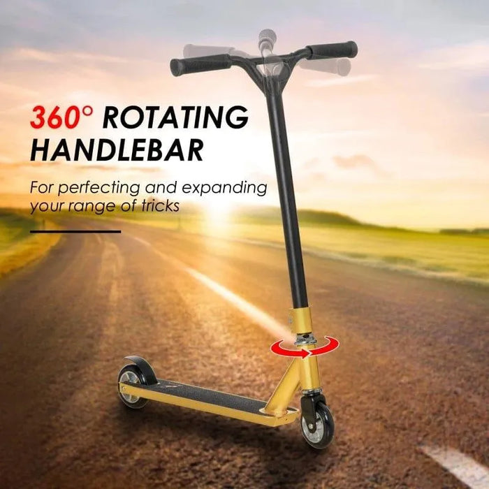 Gold stunt scooter with 360 swivel handlebar on outdoor road at sunset