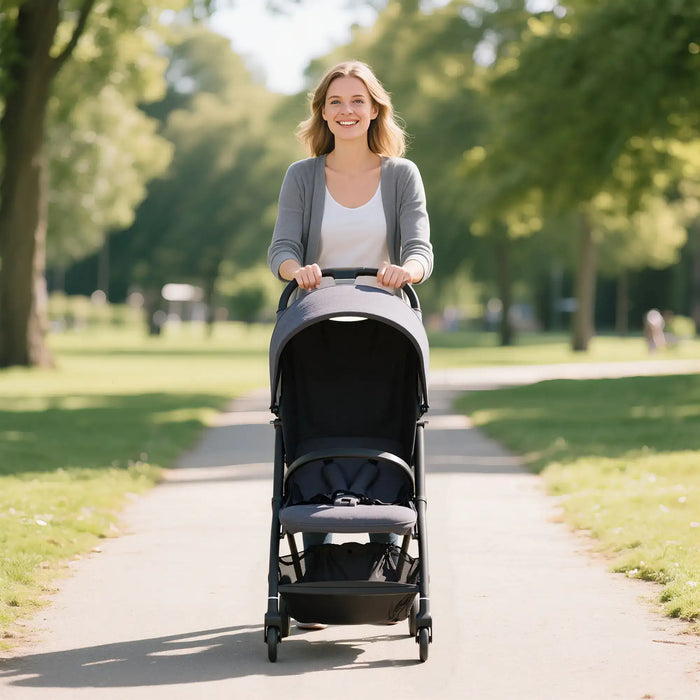 Woman pushing a stroller in a park