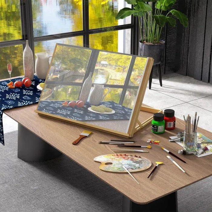 Beechwood desktop table easel with adjustable angle, art supplies, and painting in studio.