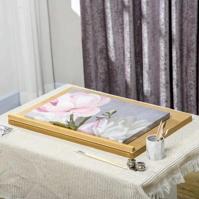 Beechwood desktop easel with floral painting, brushes, and art supplies on table