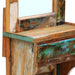Close-up of rustic wooden vanity table with distressed green and brown paint finish and small drawer