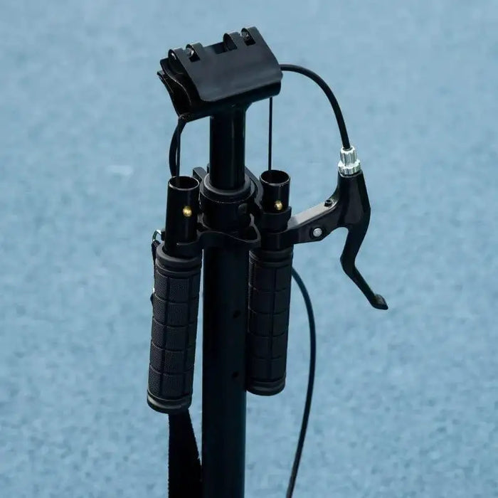 Folding black kick scooter handlebar with brake lever on blue background