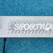 Close-up of green Homcom kick scooter deck with SPORTNOW logo on blue textured ground.