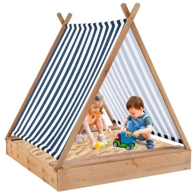 Kids playing in wooden teepee sandbox with striped sun cover and toys