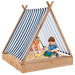 Kids playing in wooden teepee sandbox with striped sun cover and toys