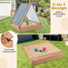 Wooden sandbox with striped teepee sun cover, benches, and detachable tool-free design in backyard