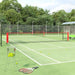 Large steel frame tennis net on outdoor court with rackets and tennis balls