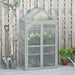 Three-tier grey wooden cold frame greenhouse with adjustable shelves on patio by fence