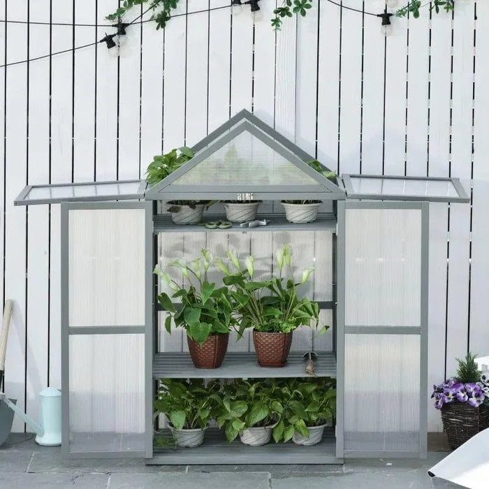 Three-tier grey wooden cold frame greenhouse with potted plants on adjustable shelves outdoors