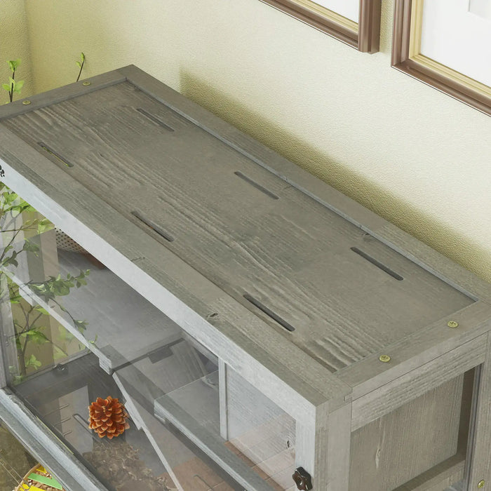 Close-up of wooden top with ventilation slots on grey three-tier small pet habitat cage