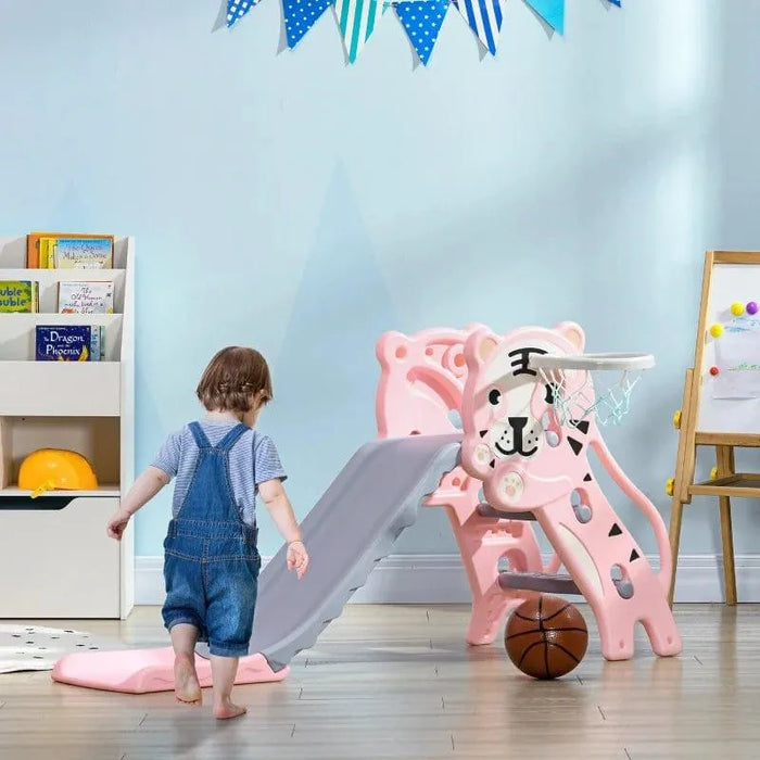 Toddler with tiger-themed pink kids slide and basketball hoop in playroom