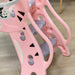 Pink tiger-themed kids slide with basketball hoop on wood floor