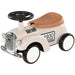 Cream toddler ride-on car toy with steering wheel, brown seat, horn, and vintage design.