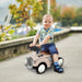 Toddler riding cream foot-to-floor sliding car toy with steering wheel and horn outdoors