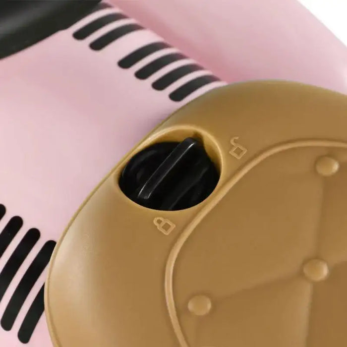Close-up of pink toddler ride-on sliding car foot-to-floor seat detail with black knob