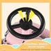Black steering wheel with horn on pink toddler ride-on car, fun toy vehicle close-up