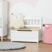 White toy storage box bench with backrest, plush toy, book, and pink basket in kids room