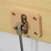 Close-up of safe gas hinge on wood panel for toy storage box bench