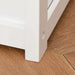 Close-up of white wooden toy storage box bench leg on wooden floor
