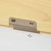 Close-up of a metal hinge attached to a light wood panel, part of toy storage box bench.