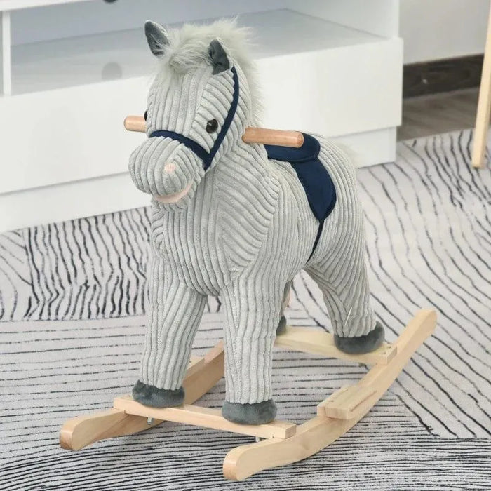 Grey and white striped plush rocking horse toy with wooden handles on a patterned rug.