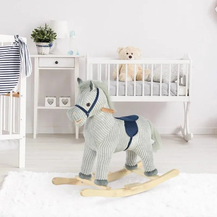 Grey and white striped plush rocking horse toy in a modern nursery with crib and decor