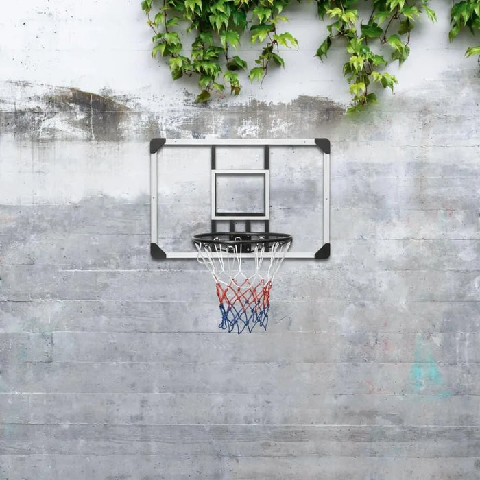 Transparent wall-mounted polycarbonate basketball backboard with steel rim on concrete wall