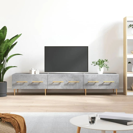 Modern living room with flat screen TV on gray console, green plants, light wood flooring, white walls