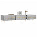 Modern grey concrete TV stand with gold handles, wooden legs, books, framed art, and vase decor