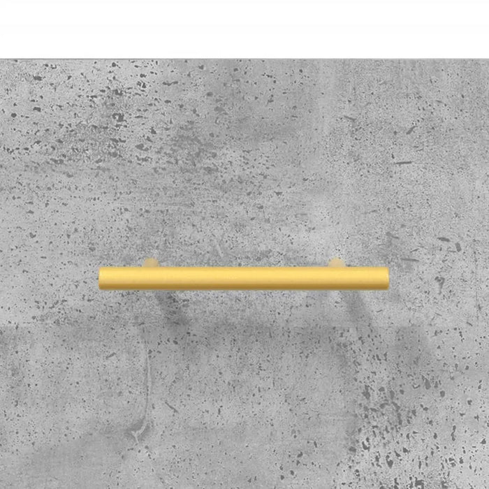Simple gold cylindrical drawer handle on textured grey concrete background