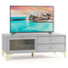 Light grey TV cabinet with gold legs, drawers, and a ribbed tempered glass door, holding a flat-screen TV