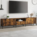 Modern smoked oak TV cabinet with metal frame under wall-mounted flat screen in stylish living room