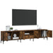 Smoked oak TV cabinet with metal frame, open cabinets showing decor, books, alarm clock, and vases