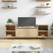 Sonoma oak TV cabinet with storage doors in modern living room with floating shelves and coffee table