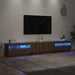 Modern artisan oak TV cabinet with RGB LED lights under floating wall-mounted flat screen in cozy living room
