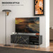Modern black marble-effect TV stand with gold accents and storage, 50-inch TV, floor lamp, and wall art