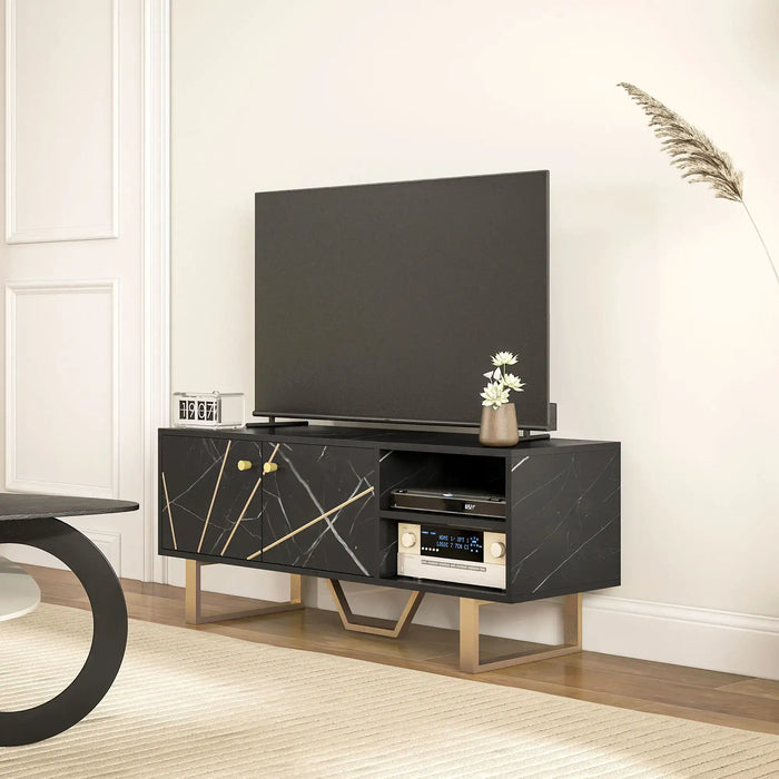 Black marble-effect TV stand with gold geometric accents and storage, supporting a flat-screen TV in modern living room