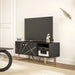 Black marble-effect TV stand with gold geometric accents and storage, supporting a flat-screen TV in modern living room