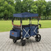 Blue and black stroller with canopy in a park setting