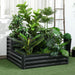 Two-tier dark grey galvanized steel raised garden bed filled with lush green indoor plants on artificial grass
